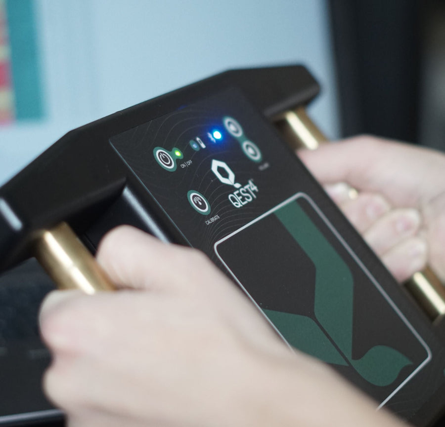 Hands resting on the Qest4 bioenergetic scanning device